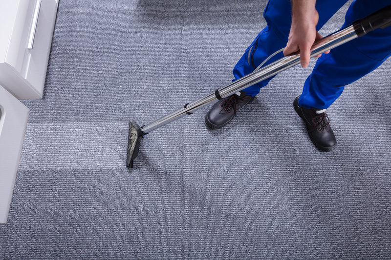 Janitor cleaning carpet