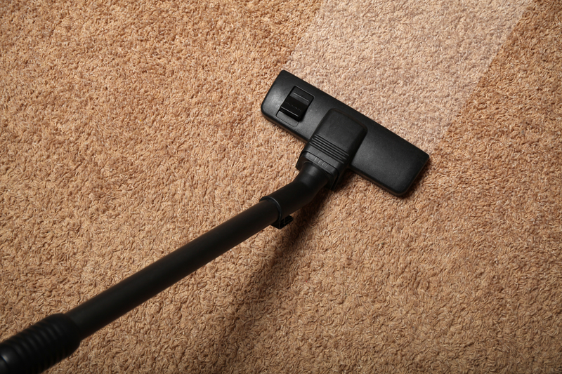 Carpet cleaning, vacuum cleaner on dirty floor.